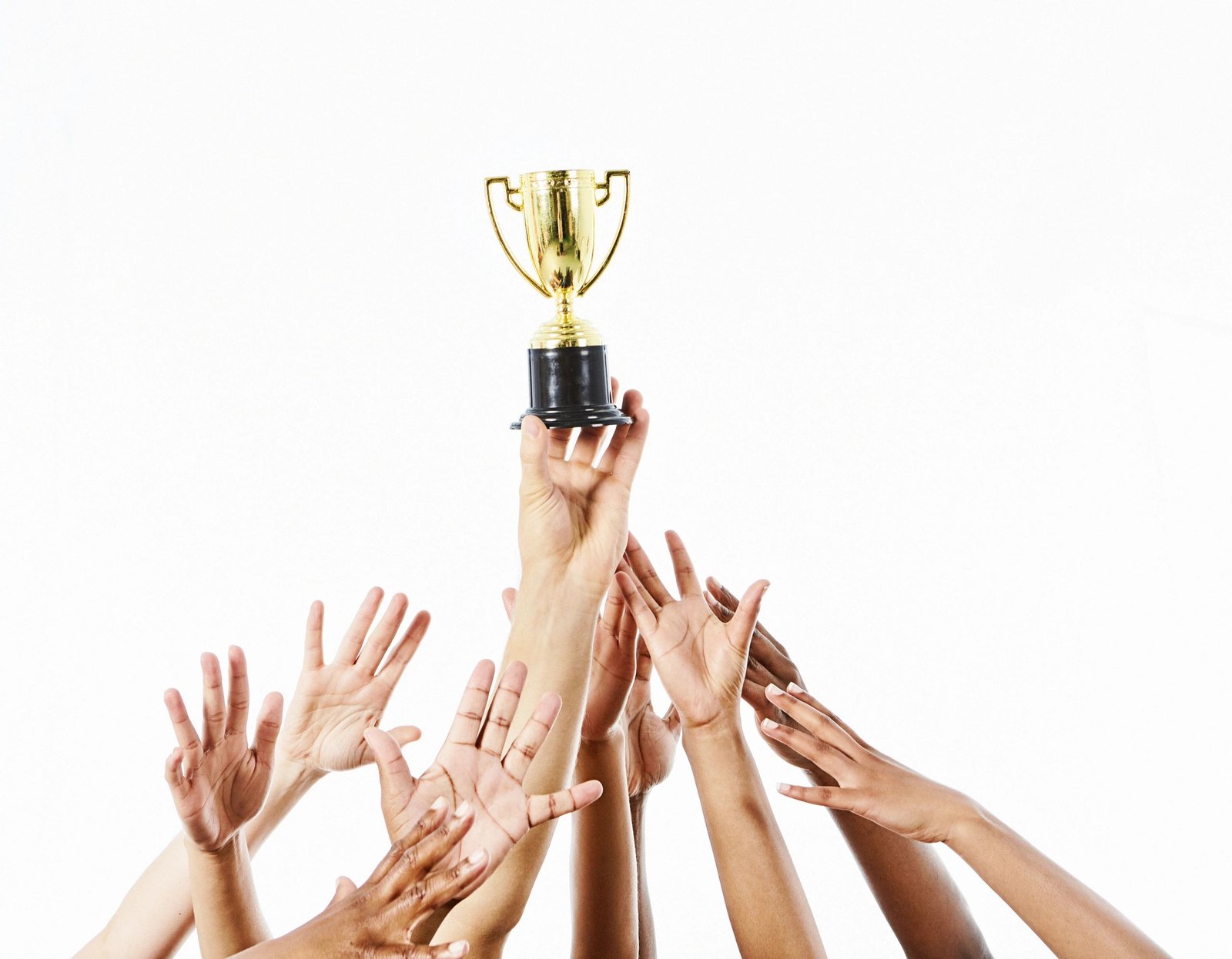 Hands reaching toward a trophy cup symbolizing achievement